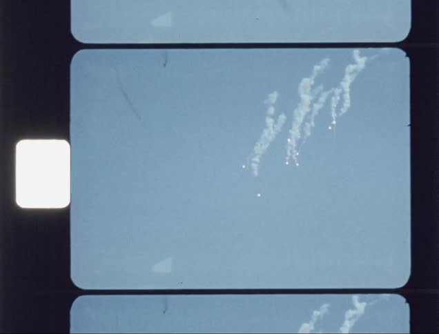 The aircraft drops objects in the sky leaving smoke behind them