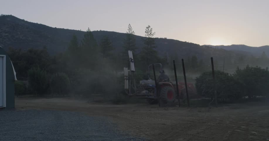 A vehicle is distributing pesticides on a farm