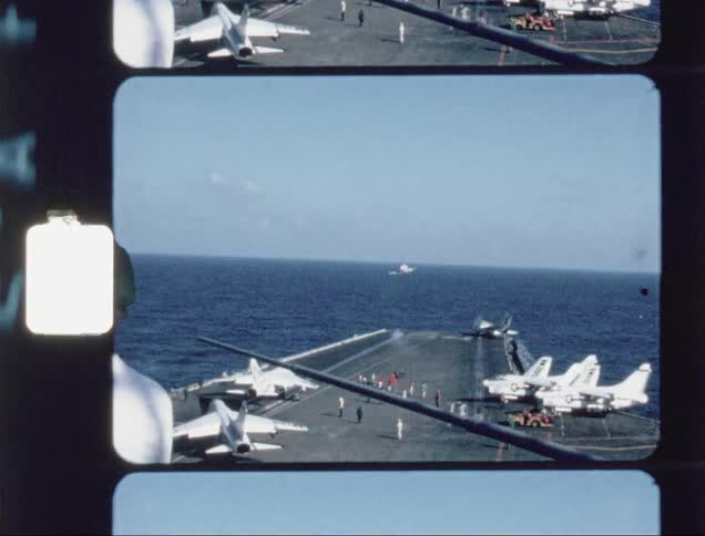 People are gathered on the runway as a jet launches