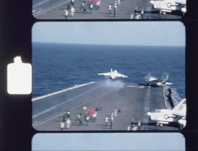 A jet jakes off as people look on from the hangar