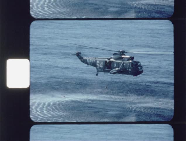 A navy helicopter attempts a rescue in the water