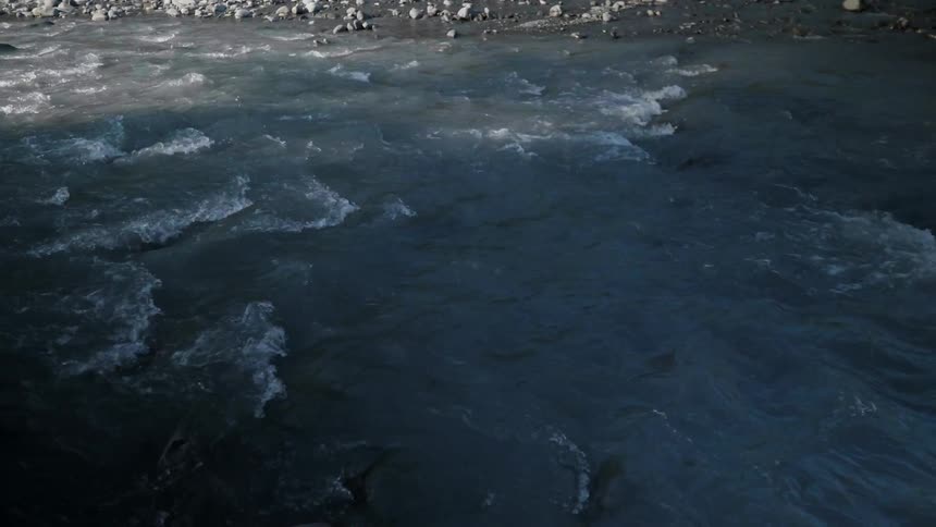The stream runs over all the stones on a sunny day