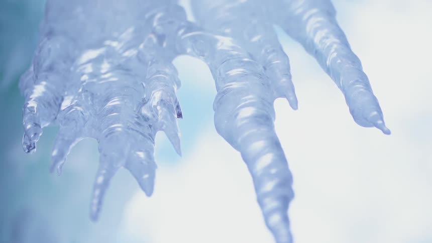 The low hanging ice is dripping water