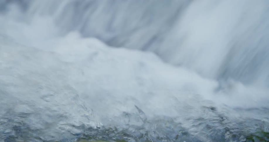 Water rushing strongly into a rocky river basin