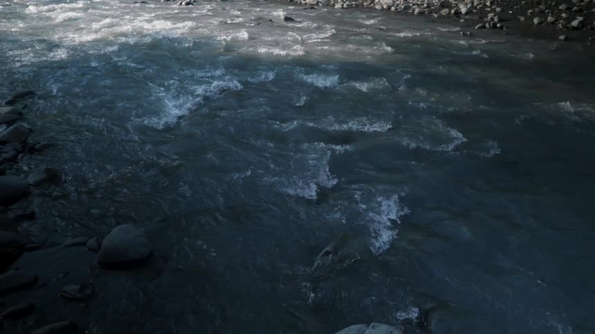 Water flows rapidly down a stream