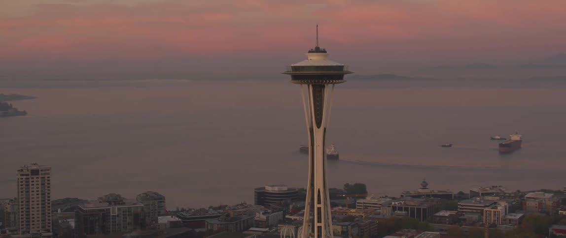 Seattle's space needle towers above the city at dusk