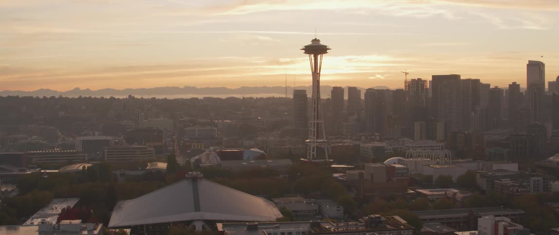 The space needle towers over seattle at sunset