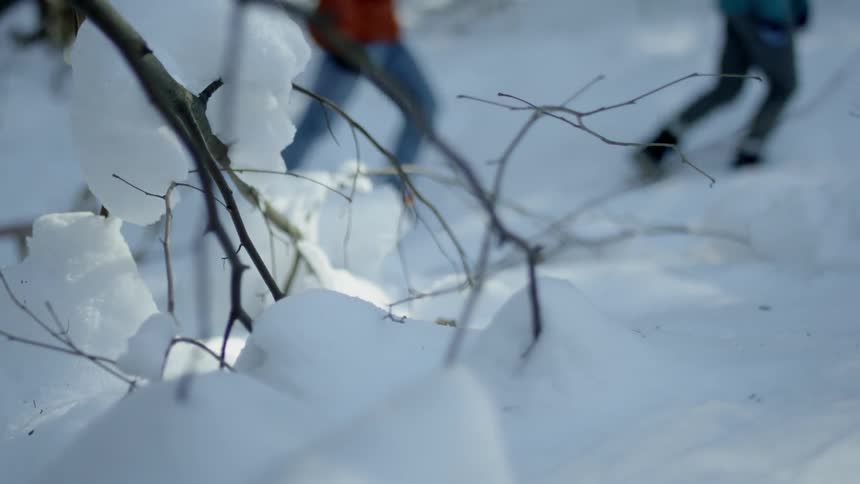Two people hike up a snowy mountain pulling a sled