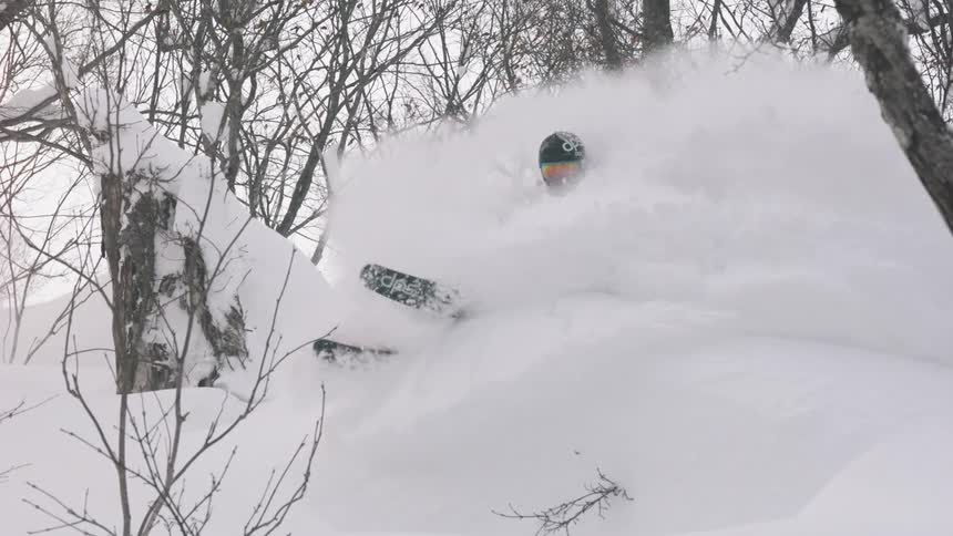 A skier turns through the snow