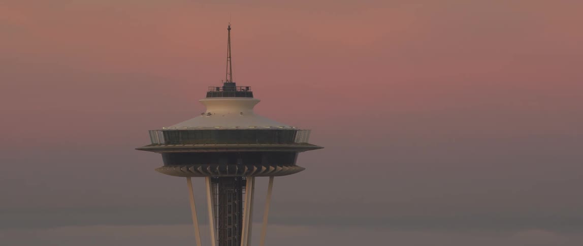 Seattle's space needle towers above the city at dusk