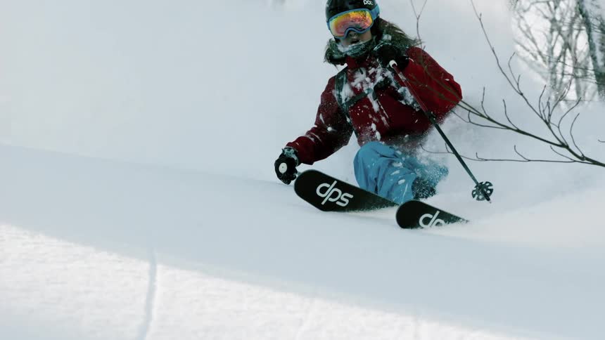 A skier turns through the snow