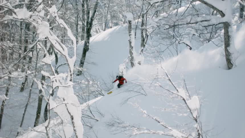 A skier in deep snow on a beautiful sunny day