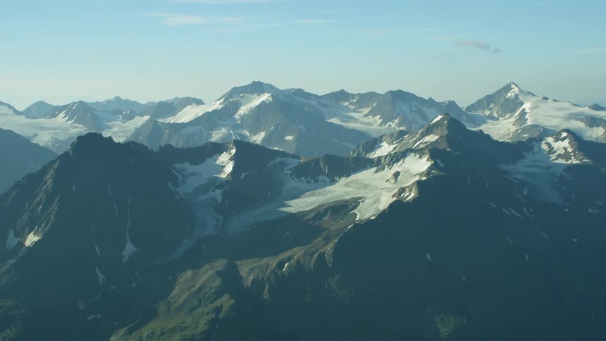 Snow covers mountains on a sunny day