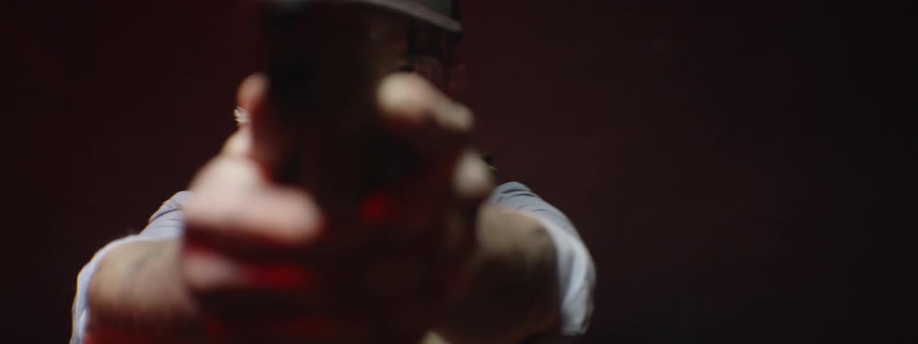 A man points a handgun at a target
