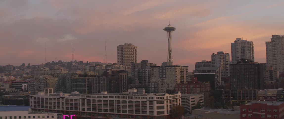The sun is setting behind the city