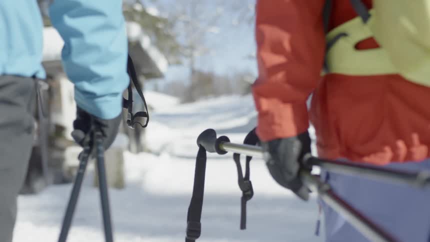 Two people hike through the snow
