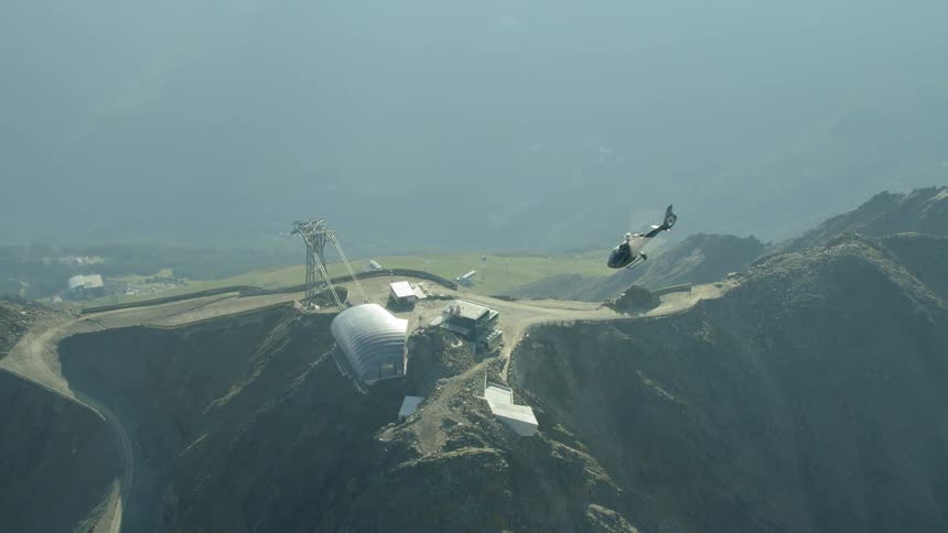 The helicopter lowers near the base set up on the mountain