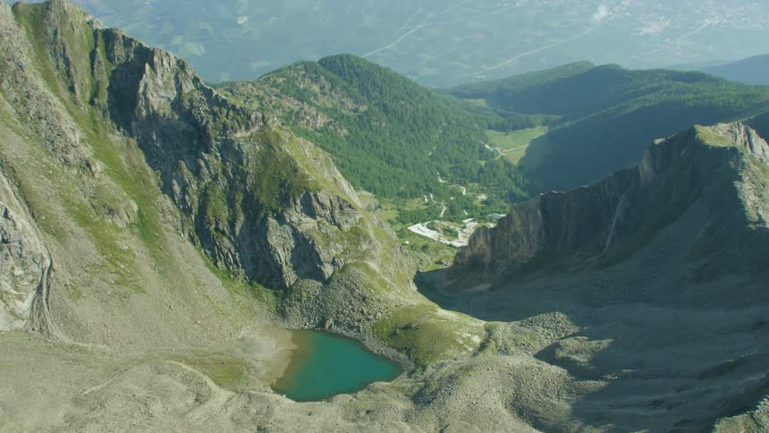 A small lake sits nestled in mountains