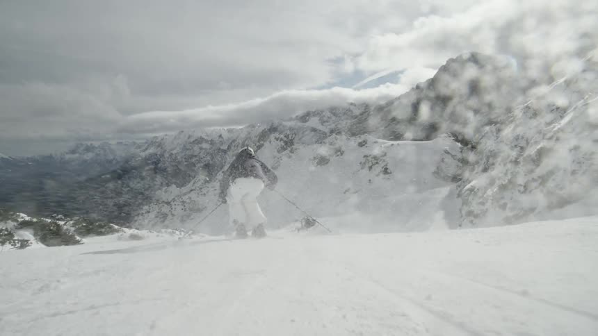 Skiers descend down the slope