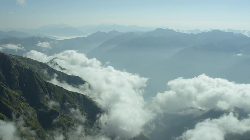 Clouds are hovering below mountain peaks during the day