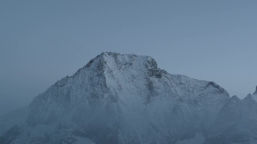 The stone mountain is covered in snow