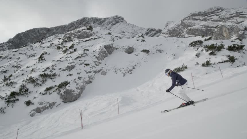A skier descends down the slope
