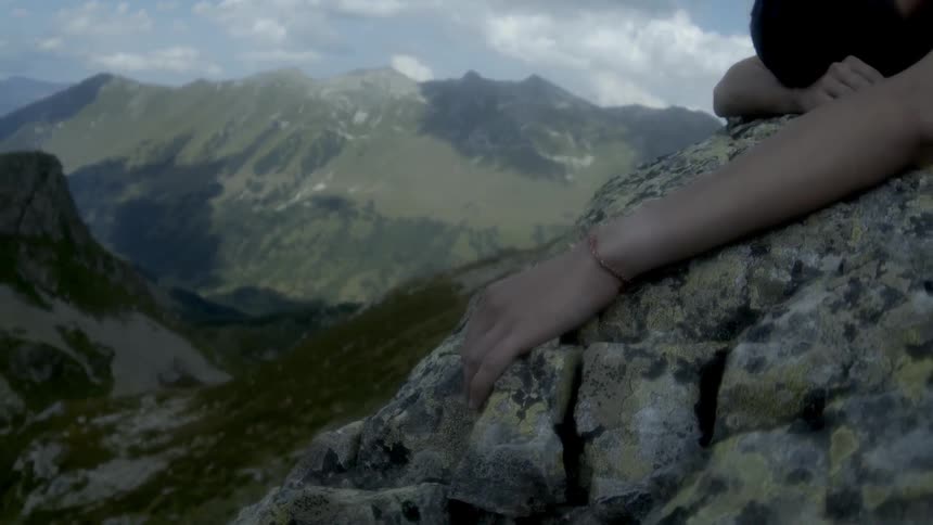 A person is passed out on the side of a mountain