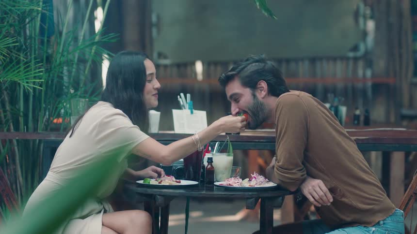 A man and woman dine on an outdoor patio