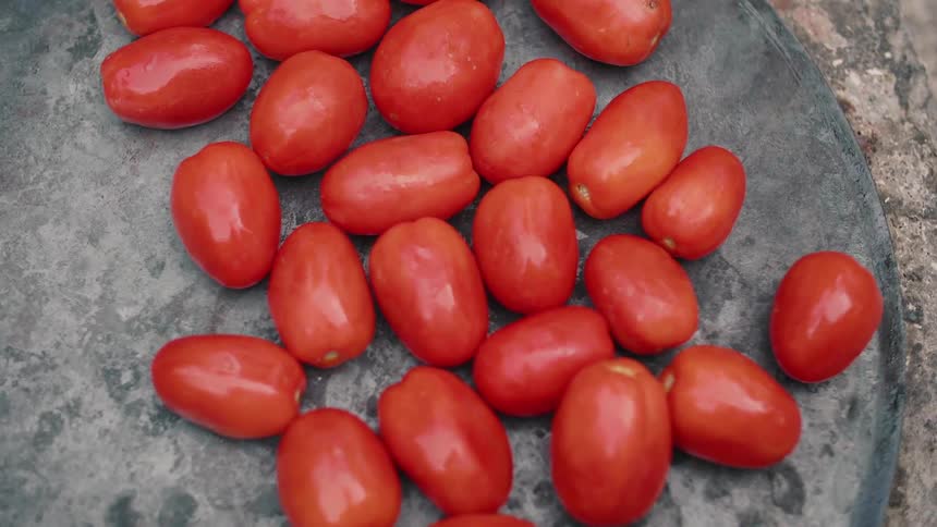 Roma tomatoes cook on a grill