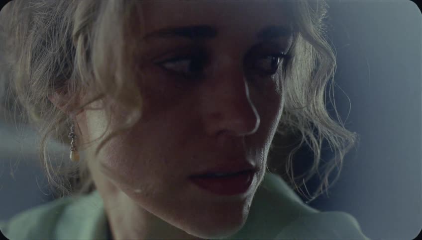 A woman cries and looks to the side