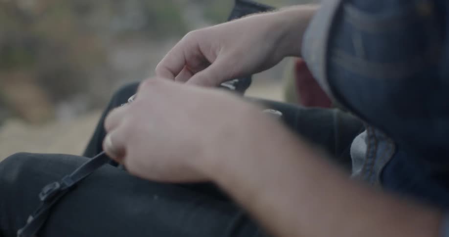 Person opens their camera and puts a roll of film in
