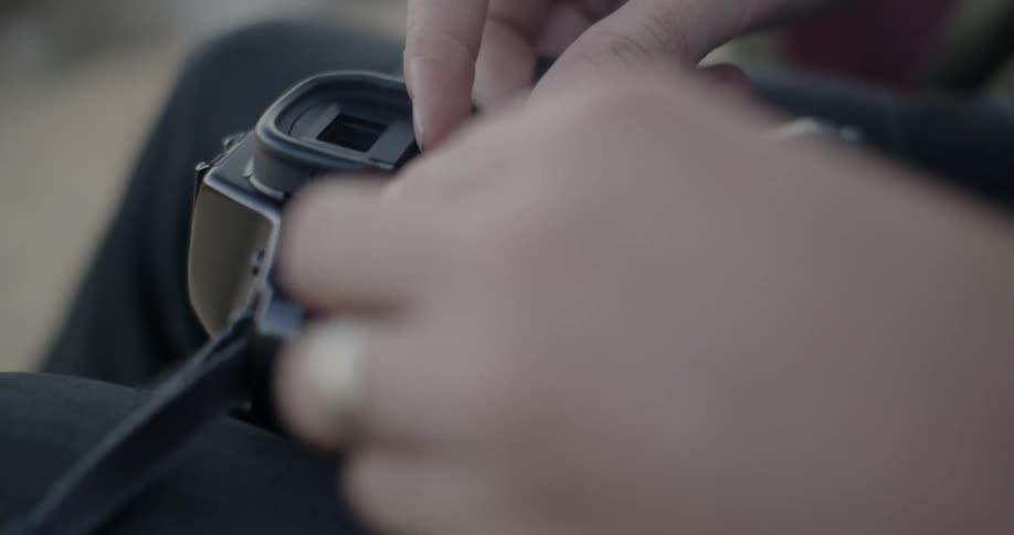 Person opens their camera and puts a roll of film in