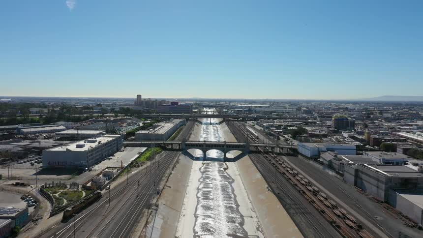 Water flows over concrete through an industrial area