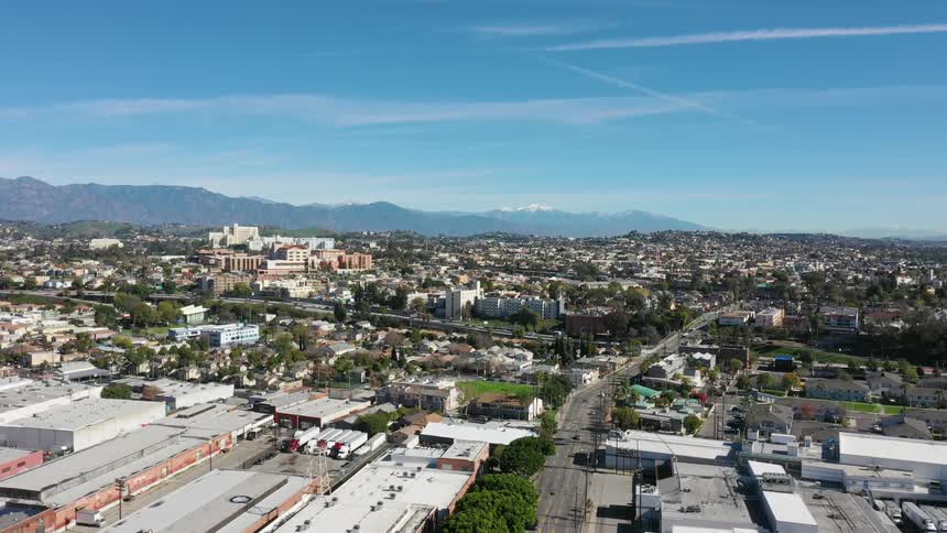 Cars drive in a city on a clear day