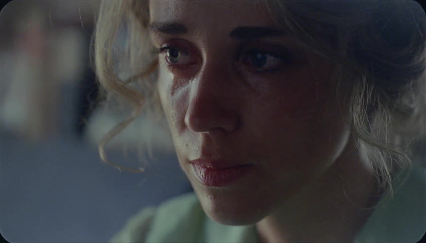A woman turns her head looking worried