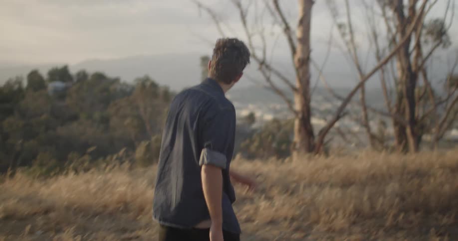 A man walks outside on a cloudy day