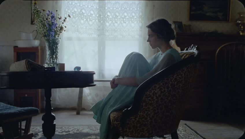 A woman sits on the chair alone in the living room
