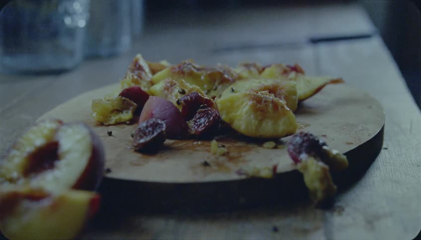 Bugs crawl on rotted fruit on a cutting board