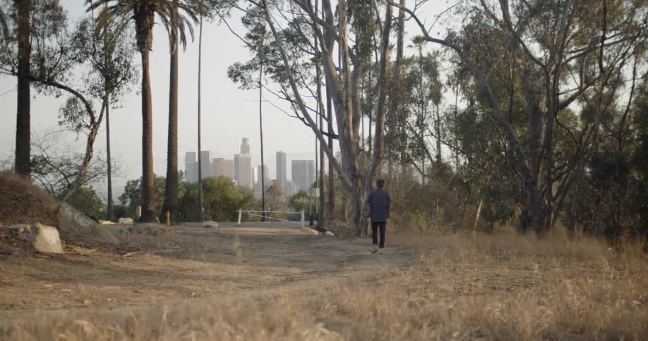 A man walks down the trail on the field