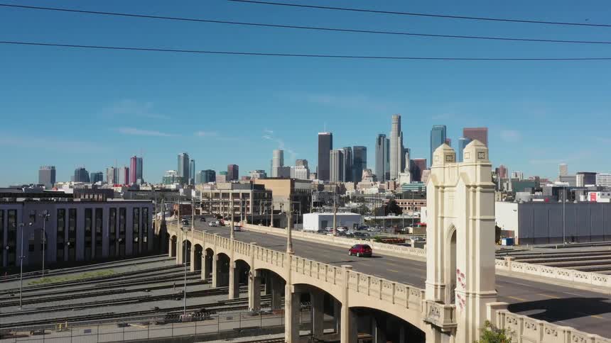 A large overpass in a big city with cars driving over it