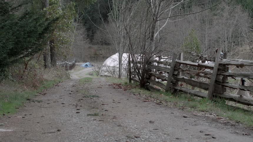 A wood fence stands on rural property