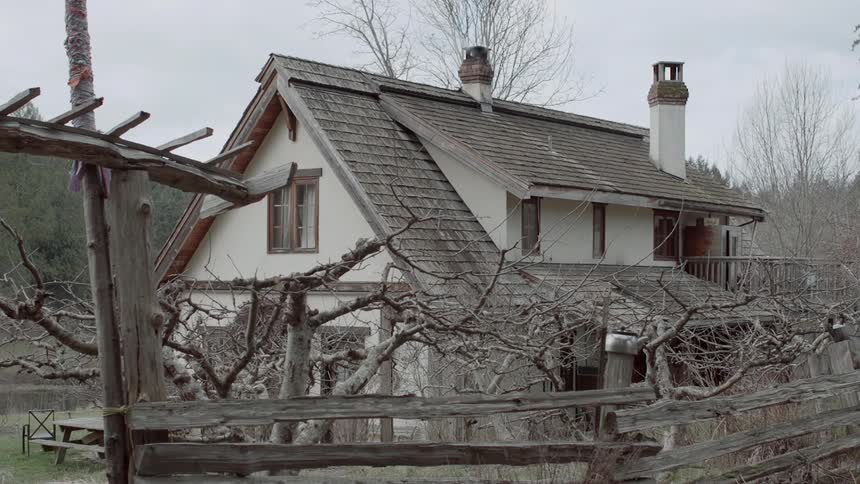 A rural house is shown on a cloudy day