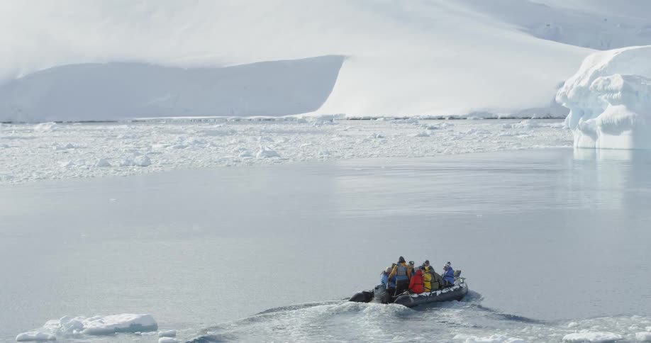 People ride in a boat in antarctica