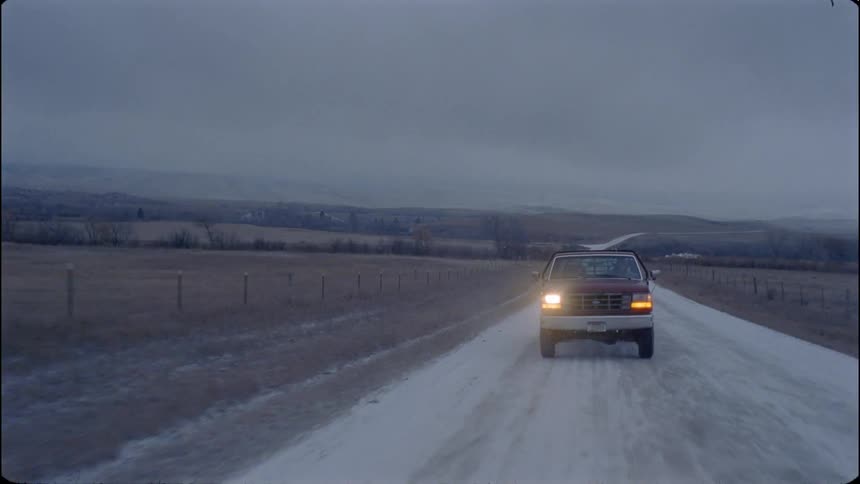 Truck drives down a country road