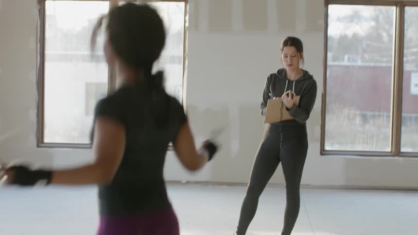 A woman takes notes as another is jumping rope