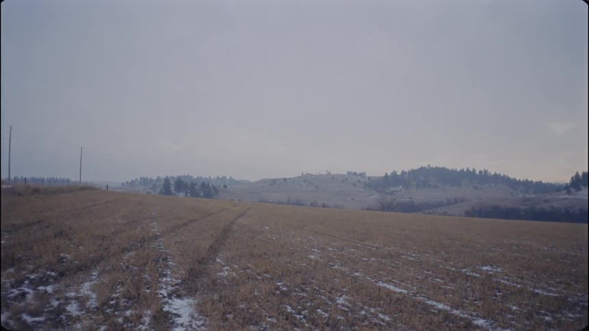 Snowy plains with hills in the background