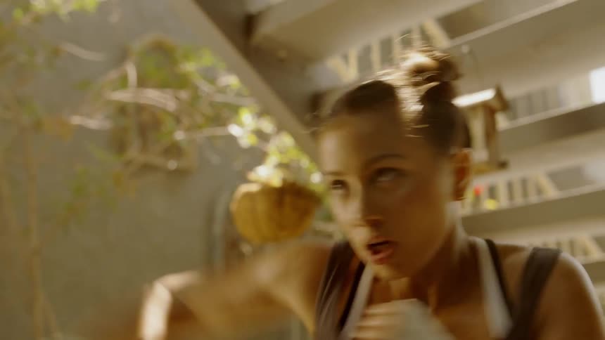A woman boxes and punches the air