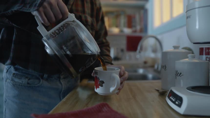 A man pours a cup of coffee