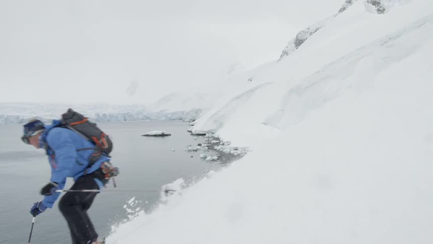 A skier makes a sharp turn before the water on the slope