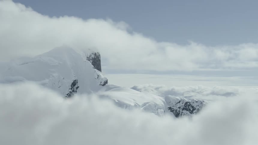 The clouds move over the mountains covering the tops